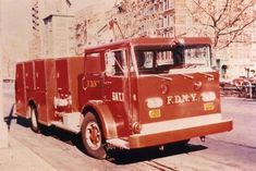 an old fire truck is parked on the street