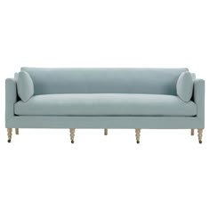 a light blue couch sitting on top of a white floor