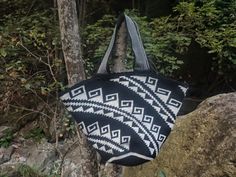 a black and white bag hanging from a tree