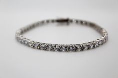 Elevate your wrist game with the PowHERful Tennis Bracelet in White Gold Plating. Its elegant design and shimmering stones make it a versatile piece that can be worn alone or stacked with other bracelets for a glamorous look. • Metal: 18K Gold Plated or White Gold Plated• Size: 7.5 inches• Closure: Lobster Clasp• Gem: Round 4mm AAA+ Cubic Zirconia stones See our Quality and Care Page for more information on our jewelry Classic Hand Set Bracelets For Party, Classic White Gold Bracelets For Party, Classic White Gold Bracelet For Party, Classic Hand-set Bracelets For Party, Classic Cubic Zirconia Bracelets For Party, Classic Diamond White Bracelets For Party, Classic Tennis Bangle Bracelet For Party, Classic Tennis Bracelet With Sparkling Stones For Party, Silver Classic Diamond Bracelet For Party