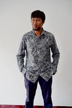 This classic long-sleeve shirt features an intricate paisley design that exudes a vintage charm perfect for the discerning gentleman. The shirt's deep blue and grey tones create a sophisticated and timeless look, making it an ideal piece for both casual and formal settings. The soft, breathable fabric ensures comfort, while the tailored fit adds a touch of elegance. The paisley pattern, popular in those before 90s period, adds a retro vibe that's both stylish and unique. Whether paired with form Classic Paisley Print Button-up Shirt, Classic Patterned Long Sleeve Shirt, Classic Long Sleeve Patterned Shirt, Classic Long Sleeve Shirt With Paisley Print, Classic Long Sleeve Paisley Print Shirt, Long Sleeve Shirt With Paisley Print For Fall, Fall Cotton Shirt With Paisley Print, Blue Paisley Print Long Sleeve Shirt, Long Sleeve Cotton Shirt With Paisley Print