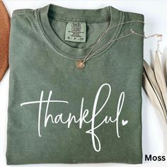 Thankful Shirt, Comfort Colors, Cute Fall Shirt, Thanksgiving Shirt, Halloween Gift, Family Thanksgiving Shirts, Womens Trendy Clothing ☀️Popular Comfort Color 1717 tshirts ☀️Preshrunk, soft-washed, garment-dyed fabric ☀️Sizes: S-4X size up for an oversized tshirt fit. great for small business owners bridal parties  birthday shirts spring outfit nature lovers Christmas gifts Teacher Gifts Care instructions: Machine wash cold inside out. Dry on low.  Shipping: Items will ship within 1-5 business Casual Halloween Tops For Gifts, Cotton Shirt With Letter Print For Fall, Green Graphic Print Shirt For Fall, Short Sleeve Halloween Top As Gift, Fall Short Sleeve Tops For Gifts, Casual Letter Print Tops For Thanksgiving, Casual Tops With Letter Print For Thanksgiving, Fall Short Sleeve Tops For Gift, Short Sleeve Tops For Fall Gift