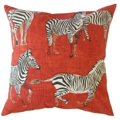 a red pillow with zebras on it