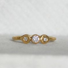 I hand forged the band out of rich 18k yellow gold, leaving a subtle hammered texture. I then added a sparkly 3.5mm diamond. Next to the glittering diamond sits little handmade lotus petals set with diamonds. If you like high quality materials, but prefer an understated classic look with a twist, then this elegant ring is the ideal choice for you. Makes the sweetest little unique wedding or engagement ring, or maybe you just want to treat yourself and wear it as a luxurious stacking ring! Detail Gold Hand Forged Diamond Ring For Anniversary, Anniversary Gold Hand Forged Diamond Ring, Gold Diamond Promise Ring In Recycled Gold, Gold Diamond Promise Ring With Recycled Gold, Gold Three Stone Stackable Anniversary Rings, Wedding Rings In Recycled Gold With Rose Cut Diamonds, Wedding Rings With Rose Cut Diamonds In Recycled Gold, Heirloom Style Recycled Gold Diamond Ring For Wedding, Hand Forged Yellow Gold Diamond Ring For Anniversary