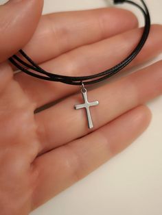 Materials: - stainless steel cross charm approx 15.5mm x 9.5 mm - braided polyester cord 1mm round Please 💗 my shop to be updated on new creations : AnaDream  - https://www.etsy.com/ca/shop/AnaDream IMPORTANT - PLEASE READ ✤ Necklace sizing (Exception: adjustable cord necklaces) ✤ It is very important to select the correct length when you place the order. Please make sure to measure your neck (or an older necklace you own) before purchasing and select the proper option. The seller will not be h Black Cross Choker As Gift, Black Cross Choker Necklace, Stainless Steel Adjustable Choker, Adjustable Black Cross Choker, Adjustable Cross Pendant Jewelry, Adjustable Cross Choker For Gifts, Adjustable Waxed Cord Choker Jewelry, Minimalist Silver Necklace With Waxed Cord, Minimalist Jewelry With Adjustable Waxed Cord