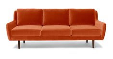 an orange couch sitting on top of a white floor