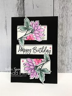 a happy birthday card with pink flowers on the front and black border, which says happy birthday