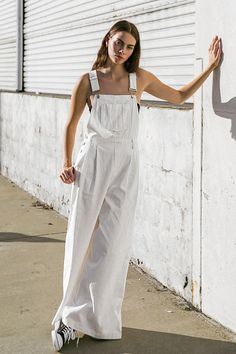 A woven overall featuring adjustable straps, center front pocket, front pleated pant, side and back pockets and wide leg. 100% Cotton Spring Overalls Jumpsuits And Rompers With Pockets, Spring Overalls With Pockets, Spring Utility Jumpsuits And Rompers With Pockets, Summer Utility Style Straight Leg Jumpsuits And Rompers, Relaxed Fit Overalls For A Day Out, Summer Straight Leg Jumpsuits And Rompers With Pockets, Spring Straight-leg Jumpsuits And Rompers With Pockets, Summer Overalls With Patch Pockets, Utility Style Overalls With Bib Front And Suspenders