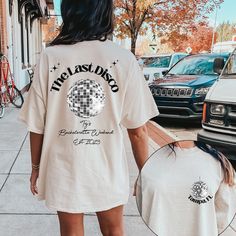 a woman is walking down the street with her back to the camera while wearing a t - shirt that says, the last disco