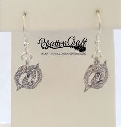 "I love these adorable Silver Pisces Earrings! The 3D charm has so much detail with two fish with sucker style mouths, eyes, scales, back fins and tail fins. It measures 1/2 inches long and 5/8 inches wide from tail fin to tail fin. It's made in the USA using lead free pewter. The French earwire is sterling silver with a coil and bead accent. Plastic earring backs are included. These lovely are ready to ship and will arrive in a gift box. View other BrattonCraft Astrology Jewelry here: https://w Themed Dangle Pierced Earrings, Themed Pierced Earrings As A Gift, Themed Earrings For Pierced Ears As Gift, Themed Gift Earrings, Nickel-free Themed Dangle Earrings, Themed Dangle Earrings, Silver Themed Earrings As A Gift, Adjustable Themed Earrings With Ear Wire, Themed Dangle Earrings As Gift