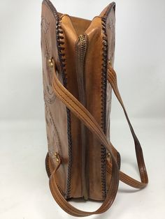 "Measures 13\" in length/ 9\" in height /4\"-7\"sides/strap drop 6\"/Good vintage condition /no issues /clean interior /smoke-free home (122)" Vintage Brown Hand Tooled Satchel For Daily Use, Retro Hand Tooled Shoulder Bag For Daily Use, Vintage Brown Hand Tooled Rectangular Shoulder Bag, Vintage Brown Hand-tooled Travel Shoulder Bag, Vintage Brown Rectangular Hand Tooled Shoulder Bag, Vintage Brown Hand Tooled Bag For Travel, Hand Tooled Vintage Brown Travel Shoulder Bag, Vintage Leather Shoulder Bag With Engraving, Vintage Leather Shoulder Bag With Engraved Details