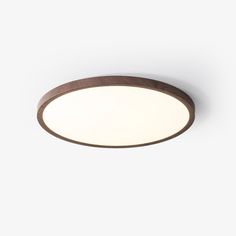 a round light fixture on a white wall with a wooden frame and dimmers