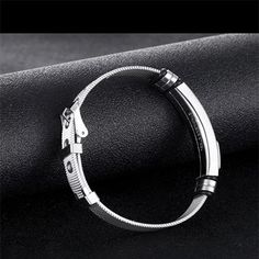 The Mens Stainless Steel Bracelet showcases a minimalist style that is quite on trend. The features include an adjustable mesh band with buckle clasp so that the bracelet can be easily adjusted to fit most men's wrist. The bracelet band width is 12mm, roughly 0.46 inches and the length can accommodate wrist from 6.5 to 8.5 inches. It is a fashionable mens bracelet that can work for all occasions, and can be gifted to teens, young men and older. This stainless steel bracelet is packaged with a je Adjustable Metal Wristband With Bracelet Strap, Trendy Silver Band Bracelet, Adjustable Silver Stainless Steel Cuff Bracelet, Adjustable Silver Stainless Steel Wristband, Adjustable Silver Wristband With Black Band, Adjustable Minimalist Stainless Steel Bracelets, Adjustable Metal Wristband In Modern Style, Adjustable Modern Metal Wristband, Adjustable Stainless Steel Cuff Bracelet