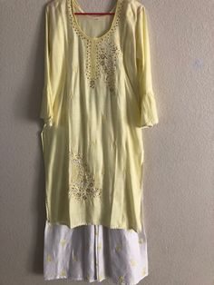 A nice lemon embroidered cotton kurti with white plaajo! Size 38-44 Length: 42' Arm length: 16 Plaajo length: 39' Spring Festive Salwar Kameez With Gota Work, Spring Salwar Kameez With Gota Work And Long Sleeves, Spring Long Sleeve Salwar Kameez With Gota Work, Bollywood Style Kurta With Gota Work For Spring, Bollywood Style Palazzo Set With Gota Work For Spring, Spring Straight Kurta Set With Gota Work, Spring Sets With Gota Work And Straight Kurta, Spring Festive Sharara With Gota Work, Spring Festive Sharara With Cutdana