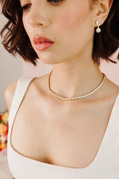 Introducing our Queen's Heart Tennis Necklace, the perfect way to add a little romance to your style! Featuring a row of heart-shaped stones set in a delicate 14k gold-plated design, this necklace brings a touch of royal charm to any outfit. Ideal for casual days, date nights, or glamorous evenings, the Queen's Heart Necklace makes every look feel extra special. It's a chic and versatile piece you'll reach for time and time again! NECKLACE FEATURES Material: Brass, White Cubic Zirconia Dimension Feminine Heart-shaped Wedding Necklace, Luxury Heart-shaped Necklace For Formal Occasions, Heart-shaped Wedding Necklace With Heart Detail, Luxury Heart-shaped Necklace For Evening, Elegant Heart-shaped Tennis Necklace, Bridal Jewelry Collection, Pearl Collection, Tennis Necklace, Bridesmaid Bracelet