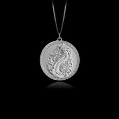 Unleash your inner fire with our Dragon pendant. Crafted with exquisite detail, this powerful piece embodies the untamed strength and mystique of the dragon, a symbol of wisdom and fierce protection. Feel the energy of this ancient guardian as it wraps you in its embrace, reminding you of your own unyielding spirit and the burning passion within. PENDANT INFORMATIONThis pendant is made of real, solid gold.• Made in USA• Material: 14k or 18k solid gold• Finish: polished• Height: 1.13" (29 mm) x W Symbolic Dragon Design Round Pendant Necklace, Spiritual Dragon Design Pendant Jewelry, Dragon Design Pendant Amulet Jewelry, Dragon Design Amulet Necklace, Burning Passion, Symbol Of Wisdom, Gold Dragon, Dragon Necklace, Mythical Creature