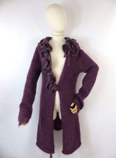 A stunning vintage mohair blend long cardigan. She features a ruffle neckline and fastens with a single hook at the front.  Size: S 10 UK Approx Bust: 38" Pit to pit: 19" Collar to cuff: 29" Pit to cuff: 19" Length: 33" She is in lovely condition and comes from a smoke free home.  Please take a look at out range of quirky mohair knitwear. Please contact me if you would like to combine postage on multiple items. Winter Chic Purple Cardigan, Elegant Purple Sweater For Fall, Purple Wool Sweater For Winter, Purple Wool Winter Sweater, Purple Long Sleeve Sweater Coat For Fall, Chic Purple Winter Sweater, Fitted Long Sleeve Ruffle Cardigan, Fitted Vintage Purple Sweater, Chic Mohair Winter Outerwear