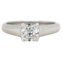 A Tiffany & Co Solitaire Lucida Cut-Cornered Square Mixed Cut Diamond Ring, four claw set in platinum on a 3.1 to 2.5mm tapered band. Tiffany & Co report 27884059/L11090091 (laser inscribed on crown) Measurements: 5.61 x 5.47 x 3.69mm, Depth: 67.5% Fluorescence: None Girdle thickness: Slightly thick Precision cut grade : Excellent, Polish grade: Excellent Symmetry grade: Very good Metal: Platinum PT950 Carat: 0.91ct Colour: F Clarity: VVS1 Cut: Square Mixed Cut Weight: 5.55 grams Engravings/Mark Classic Radiant Cut Diamond Ring With Center Stone, Classic Radiant Cut Promise Ring, Timeless Gia Certified Princess Cut Wedding Ring, Gia Certified Timeless Princess Cut Diamond Ring, Gia Certified Princess Cut Diamond Ring, Classic Radiant-cut Platinum Jewelry, Classic Radiant Cut Platinum Jewelry, Timeless Platinum Ring With Classic Cut, Classic Rings With Vvs Clarity And Cushion Cut