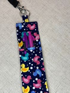 a blue tie with colorful ducks and bubbles on it is hanging from a lanyard