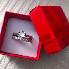 an open red box with a ring in it