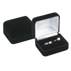 an open black velvet ring box with two gold wedding rings in it and the lid opened