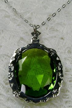 "Simulated Green Peridot Pendant Bubble Design#P10 Custom Made Inspired by Victorian era designs, I now offer this lovely Antique reproduction in sterling silver. The flawless simulated/man-made 22ct faceted green peridot gemstone is 24mm long (15/16th\") and 18mm in width (3/4th\"). The entire pendant is 1.5\" long and 7/8\" wide. The chain (if chosen) is between 18-20 inches in length and is marked 925 as well. Notice the beautiful craftsmanship of the Victorian filigree setting. This pendant Green Oval Necklace For Formal Occasions, Formal Green Oval Necklace, Green Oval Necklace For Wedding, Classic Green Jeweled Necklace, Green Jeweled Necklaces For Anniversary, Green Pendant Jewelry With Intricate Design, Green Jeweled Necklace For Anniversary, Green Intricate Design Pendant Jewelry, Green Oval Necklace For Anniversary