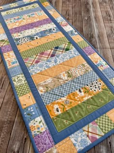 a quilted table runner on a wooden floor