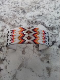 "I use size 15 seed beads. The length is 6\" and width is 1\". Product is an adjustable cuff bracelet with a pig skin covering." Native Beading, Native Beading Patterns, Native American Beaded Earrings, Native Beadwork, Native American Beadwork, Native Design, Beadwork Patterns, Beading Ideas, Beaded Belt