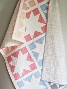 three quilts laid out on top of each other in different colors and shapes,