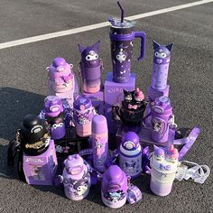 a pile of purple stuff sitting on top of a parking lot next to each other