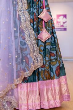 Stand out in this beautiful Grey and Light Pink Kanchi Pen Kalamkari Lehenga! This gorgeous ensemble will be the perfect addition to any wardrobe with its intricate and eye-catching design. The lehenga is made of premium quality fabric and features a unique kalamkari pattern that will turn heads. Make a statement with this luxurious and unique piece! Traditional Tissue Silk Palazzo Set With Zari Work, Festive Tissue Silk Palazzo Set, Bollywood Style Tissue Silk Palazzo Set With Zari Work, Navratri Chandbali-shaped Tissue Silk Lehenga, Traditional Tissue Silk Palazzo Set For Designer Wear, Designer Palazzo Set With Traditional Drape And Pallu, Transitional Chanderi Lehenga With Gota Work, Traditional Drape Sets With Gota Work For Reception, Transitional Tissue Silk Lehenga With Traditional Drape