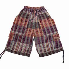 "Handcrafted for comfort and style, our cargo shorts blend the best of boho vibes with practicality. Whether you're gearing up for Burning Man, a music festival, or just a casual day out, these handmade shorts are the ultimate summer essential. With a high waist design and ample pockets, they cater to both men and women, ensuring you're ready for any adventure. Elevate your streetwear game with these versatile, baggy shorts, perfect for rocking your inner hippie or rave-ready ensemble. Embrace the freedom of movement and storage with our cargo shorts - the ultimate fusion of fashion and function! This pair of shorts was handmade by Ecuadorian artisans using the foot-treadle loom technique. It has a drawstring in the waist and the pant legs have tying drawstring hems.  Materials: 75% cotton Bohemian Bottoms With Pockets For Vacation, Vacation Bermuda Pants With Pockets, Summer Cotton Bottoms With Cargo Pockets, Short Length Cargo Shorts For Vacation, Casual Festival Shorts, Multicolor Hippie Shorts For Vacation, Beach Cotton Cargo Pants With Pockets, Cotton Cargo Pants With Pockets For Beach, Bohemian Shorts With Pockets For Summer