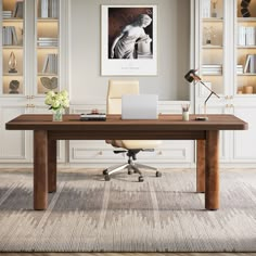 a desk with a laptop on it in front of some bookshelves and shelves