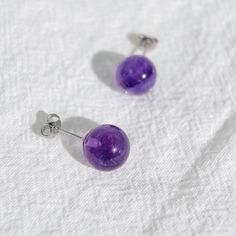 Material: natural crystal + S925 sterling silver Size: 10mm purple gemstone Item Weight：3.00g Style: minimalist style ♥ Dress up your ears with these Amethyst Studs and immerse yourself in the magical allure of the mysterious and romantic purple series. Wear them with confidence and shine among the crowd, embracing the captivating beauty of natural amethyst. ♥ Handcrafts: - Handmade with meticulous attention to detail - Features a 10mm purple gemstone that exudes a deep and transparent purple hu Minimalist Sterling Silver Round Crystal Earrings, Minimalist Sterling Silver Crystal Earrings, Sterling Silver Round Crystal Earrings For Everyday, Minimalist Round Nickel-free Crystal Earrings, Minimalist Hypoallergenic Sterling Silver Crystal Earrings, Minimalist Crystal Earrings For Gift, Minimalist Sterling Silver Earrings With Round Stone, Purple Round Minimalist Jewelry, Minimalist Purple Round Jewelry