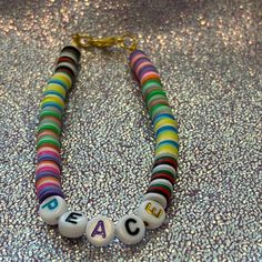 Hand Crafted Multi Colored Clay Beads Girls Bracelet With Peace Letters. Casual Beaded Bracelets With Letter Beads, Casual Round Beaded Bracelets With Letter Beads, Casual Beaded Friendship Bracelets For Birthday, Casual Beaded Friendship Bracelets For Birthdays, Casual Beaded Bracelets For Birthday, Casual Colorful Beads Bracelet For Birthday, Casual Colorful Beaded Bracelets For Birthday, Casual Colorful Beaded Bracelet For Birthday, Adjustable Colorful Beads For Birthday