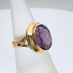 Elegant 9 carat gold ring set with one oval   Synthetic Amethyst with dimension 10 mm x 15 mm Size of the ring is L 1/2 (US Size 6) Weight of the ring 5.58 grams Oval Faceted Rings In Fine Jewelry Style, Elegant Oval Faceted Sapphire Ring, Classic Purple Signet Ring, Elegant Amethyst Signet Ring Hallmarked, Elegant Amethyst Hallmarked Signet Ring, Heirloom Oval Faceted Ring, Purple Elegant Signet Ring For Formal Occasions, Elegant Hallmarked Amethyst Signet Ring, Classic Purple Signet Ring For Formal Occasions