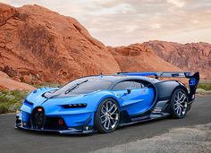 a blue bugatti is parked on the road in front of some red rocks