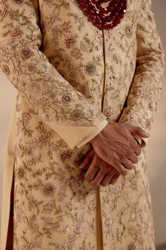 Pale Gold Sherwani | Jatin Malik Introducing our exquisite golden heavy hand-embroidered sherwani set, a true work of art. This sherwani features an intricate embroidery technique combining zardosi and aari work, showcasing unparalleled craftsmanship and attention to detail. Perfect for those seeking to make a grand and sophisticated statement, this sherwani set epitomizes luxury and traditional elegance. Included in purchase: Sherwani, Kurta, Churidar Product Specification Color: Golden Fabric: Linen silk Occasion: Engagement, Wedding, Bridal, Reception Style: Sherwani, Kurta, Churidar Care: Dry Clean Work: Hand Embroidery Customization options:Can be customized in any color or style Note: A stylist will contact you to confirm measurements after your order is placed.Estimated delivery tim Gold Sherwani, Jatin Malik, Embroidered Sherwani, Blouse Yoke, Dhoti Pants, Indian Groom, Indian Wedding Outfits, Intricate Embroidery, Pale Gold