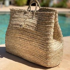 a large straw bag sitting on top of a swimming pool