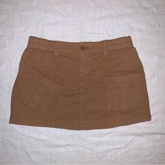 Khaki / Tan / Brown Cargo Skirt With Pockets Flattering And Comfortable Fit Excellent Condition- Never Worn! Brown Cotton Mini Skirt With Pockets, Casual Beige Mini Skirt With Pockets, Casual Brown Lined Skirt, Urban Outfitters High Waist Casual Skirt, Relaxed Fit Brown Cotton Skirt, Urban Outfitters Casual High Waist Skirt, Casual High Waist Skirt From Urban Outfitters, Urban Outfitters Casual Lined Skirt, Urban Outfitters Casual Mini Skirt