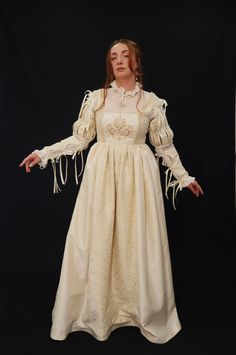 This beautiful Renaissance-style dress is made with taffeta creme ivory fabric and ivory and gold brocade fabric. The chamise dress is made from transparent opaque organza fabric with handmade beads and pearl embroidery. This price includes the dress, the detachable sleeves, and the CHEMISE dress. available in size 10 UK, 8 USA, M  Suitable for the following measurements : High 168 cm Bust 92-98 cm          36.2- 38.5in Waist 74-80 cm            29.1- 31.4 in Arm perimeter 28-32 cm Taffeta Ball Gown Wedding Dress, Marie Antoinette Victorian Dress For Fancy Dress, Marie Antoinette Victorian Dress With Fitted Bodice, Elegant Corset Ball Gown Dress For Costume, Elegant Ball Gown Corset Dress For Costume, Fitted Taffeta Dress For Wedding, Fitted Taffeta Gown For Wedding, Marie Antoinette Style Fitted Fancy Dress, Fitted Taffeta Wedding Dress