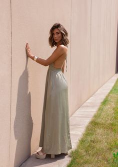 Unleash your inner beach babe in our Sydney Sundress! This olive halter neck sundress is the perfect addition to your summer wardrobe. Not only does it keep you cool in the sun, but its playful halter neck adds a touch of flirty flair. Bring on the sunshine (and compliments)! Fabric 97% polyester, 3% spandex Chic Backless Maxi Dress For Summer, Casual Backless Dress With Spaghetti Straps For The Beach, Summer Sundress With Spaghetti Straps And Backless Design, Sleeveless Tie Back Backless Dress For Summer, Summer Backless Dress For Day Out, Backless Summer Dresses For Day Out, Sleeveless Backless Dress For Summer Day Out, Chic Backless Sundress For Beach, Chic Summer Backless Dress For Vacation