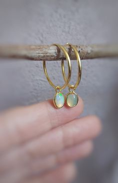 This cute sterling silver and gold plated opal gemstone earrings are handmade and unique. Because of this there may be a small difference in each piece. I used sterling silver (925k) and opal gemstone with silver smithing technique. Then I made gold plated. There are the colors of the rainbow in this opal gemstone. This lovely opal earrings are suitable for daily and night use. Also it can be a beautiful gift alternative for christmas and mother's day. Radius of silver hoop earrings is 2 cm. Dim Opal Huggie Earrings Gift, Small Hoop Opal Earrings For Gift, Opal Hoop Earrings As A Gift, Opal Huggie Hoop Earrings Gift, Opal Huggie Hoop Earrings For Gifts, Opal Huggie Hoop Earrings As A Gift, Gold Hoop Opal Jewelry, Gold Opal Small Hoop Jewelry, Gold Opal Hoop Jewelry