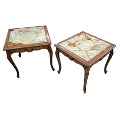 two tables with marble top sitting next to each other