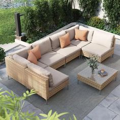 an outdoor living area with couches and tables