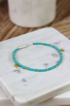 This dainty beaded bracelet can be paired with gold jewelry. Give this as a gift to a friend or gift it to yourself. Turquoise Bracelets With Tiny Beads As Gift, Turquoise Bracelets With Tiny Beads For Gifts, Trendy Turquoise Bracelets With Tiny Beads, Turquoise Beaded Bracelets With Gold Beads As Gift, Elegant Turquoise Beaded Bracelets With Tiny Beads, Minimalist Beaded Turquoise Bracelet, Minimalist Turquoise Beaded Bracelets, Trendy Turquoise Beaded Bracelets As Gift, Trendy Turquoise Beaded Bracelets For Gifts