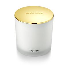 the apothheke candle in white and gold is shown on a white surface