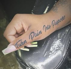 a hand with writing on it that says turn pain into purpose written in cursive font