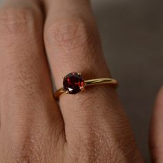 This is a gorgeous handmade creation. Its beauty is its simplicity & Elegance. The 7mm round cut garnet is crafted in solid sterling silver and with yellow gold plated. All item is sent in a beautiful gift box You can realize more lovely stuff clicking the link https://www.etsy.com/shop/knightjewelry?refshopsection_shophome_leftnav Please leave the correct address and you phone number for delivering successfully. Yellow Gold Garnet Rings, Yellow Gold Garnet Rings With Round Cut, Yellow Gold Garnet Birthstone Ring, Garnet Birthstone Ring In Fine Jewelry Style, Garnet Birthstone Ring With Prong Setting In Fine Jewelry, Yellow Gold Garnet Solitaire Jewelry, Classic Yellow Gold Garnet Birthstone Ring, Classic Garnet Birthstone Ring In Yellow Gold, Formal Gold Garnet Birthstone Ring