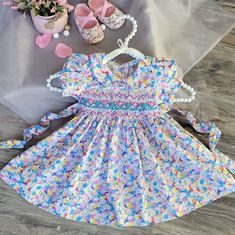 Celebrate Your Baby's Special Day In Style With Our Floral Smocked Embroidered Dress. Beautifully Crafted Garment That Exudes Elegance And Charm. Timeless Design | Vintage Victorian Floral Print | No Lined | Not See-Through. Details : - Breathable 100% Cotton. - Peter Pan Collar And Puffy Sleeves. -Precious Turquoise Rose-Buds And Pink Zic Zac Hand Smocking Across The Chest. - Matching Buttons To Assist With Dressing On A Back. - Adjustable Waist Tie. Runs True To Size. ! ! Matching Bloomers For Multicolor Smocked Dress For Summer Playtime, Playful Fitted Smocked Dress For Playtime, Fitted Multicolor Dress For First Birthday, Playful Fitted Smock Dress, Cute Multicolor Smocked Dress, Spring Fitted Smocked Dress For Playtime, Cute Fitted Multicolor Smocked Dress, Cute Multicolor Fitted Smocked Dress, Cute Smocked Dress For Baptism In Spring